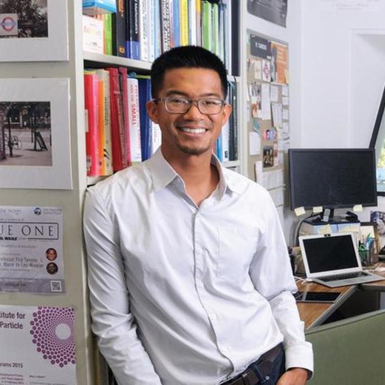 Flip Tanedo stands in his office